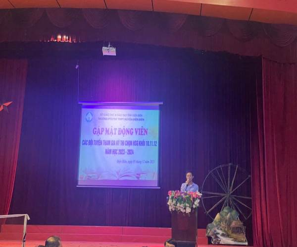 Description: A person standing in front of a stageDescription automatically generated